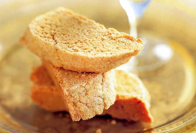 The half-moon biscotti cookies on a yellow glass plate