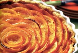 A Valencian orange tart with slices of oranges in a circular pattern in a pastry crust