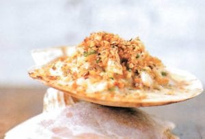 Baked seafood imperial--crab, shrimp, scallops, and calamari in a cream sauce, topped with bread crumbs and baked--on a water cracker