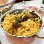 A copper pot of bacalhau a Bras--or Portuguese scrambled eggs, salt cod, potatoes, onions, olives, and parsley