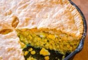 A corn pie, with a sliced remove, the filling of corn, egg, celery, onion, parsley can be seen