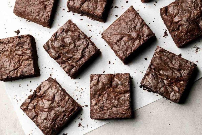 Squares of care-package brownies on parchment paper