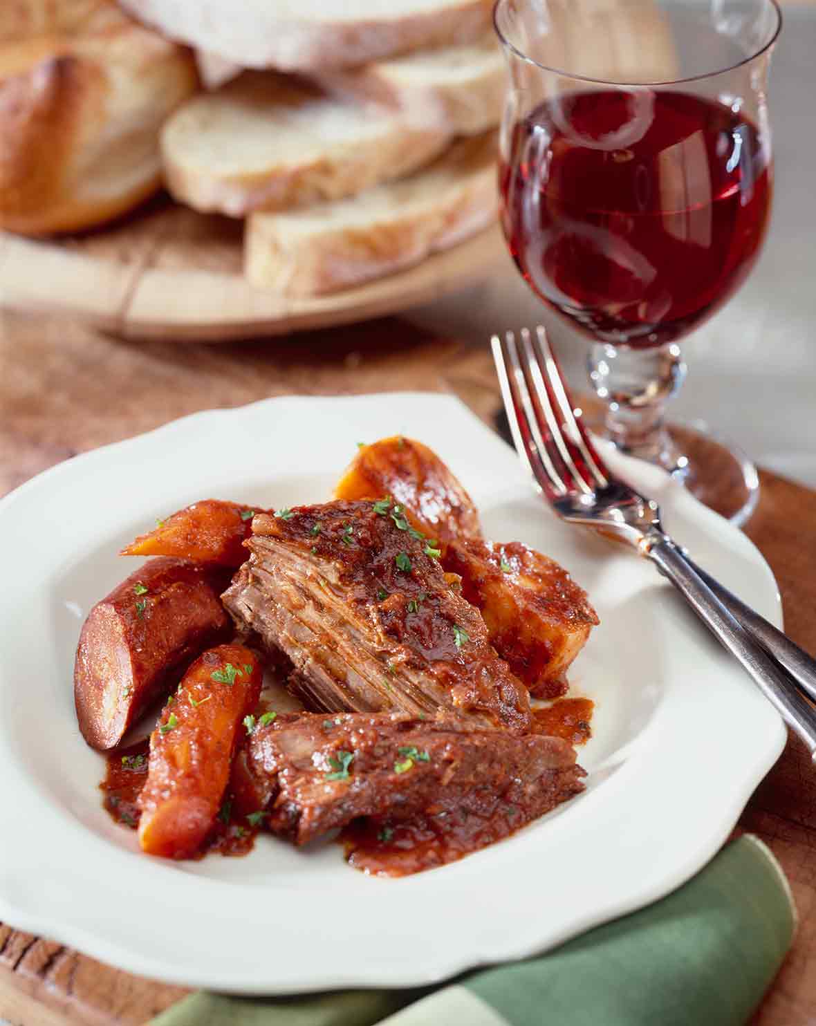 Azorean food: white bowl with carne assada--braised beef with carrots, potatoes, and Portuguese sausage, chouriço