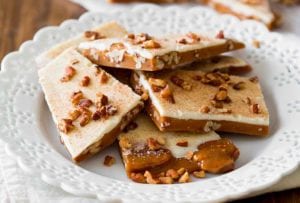 Plate of pumpkin spice toffee--made with toffee, pumpkin spice, white chocolate, and pecans