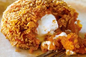 An inside-out sweet potato coated in corn flakes, with a marshmallow center.