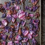 Roasted red cabbage on a cooling rack set in a baking sheet