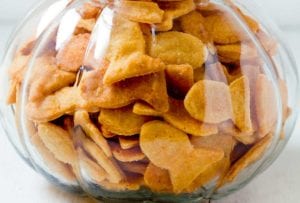 A glass jar filled to the brim with cheesy fish crackers.