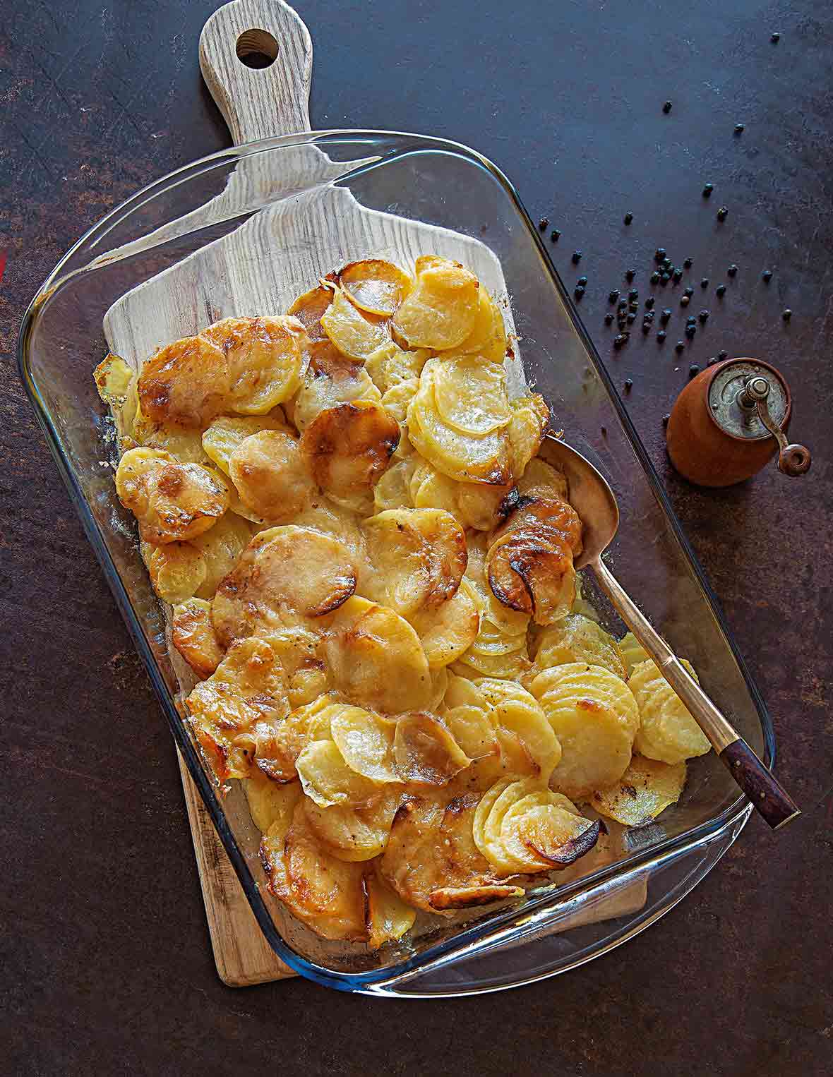 A glass casserole dish filled with golden brown easy scalloped potatoes