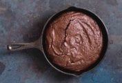 A cast-iron skillet filled with chocolate brownie