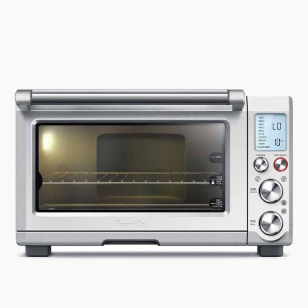 A Breville Smart oven with a light on inside.
