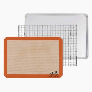 The French Pantry 3 piece baking gift set consisting of a half-sheet pan, silicone baking mat, and a cooling rack.