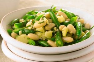 A white bowl filled with pecorino and bean salad.