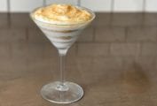 A serving of Portuguese sawdust pudding layered in a martini glass.