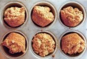 Six Alabama muffin biscuits in a muffin tin.