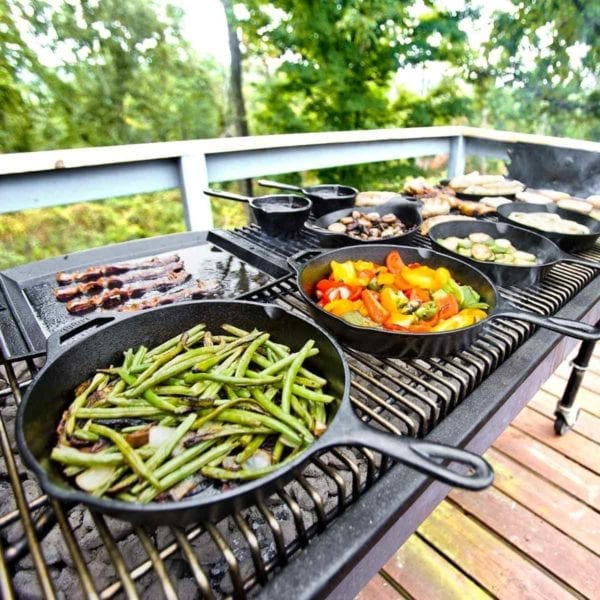 Lodge Pre-Seasoned Cast Iron Skillet With Assist Handle on a grill.