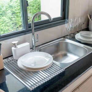 Foldable Multi-Use Drying Mat on sink with plates.