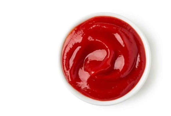 A small white bowl filled with homemade ketchup.