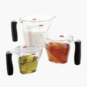 3 measuring cups filled with liquid
