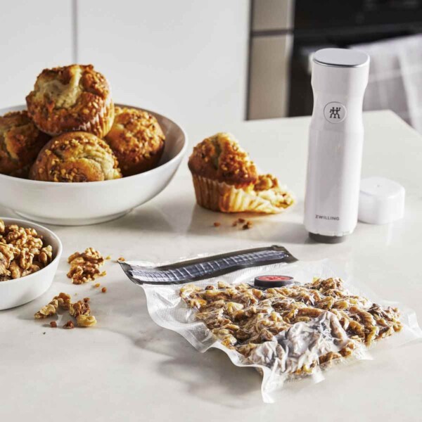 A photo of a Zwilling Fresh & Save vacuum bag on counter with walnuts.