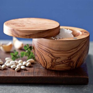 Berard Olive Wood Handcrafted Salt Keeper shown on wood cutting board with white beans and oregano.