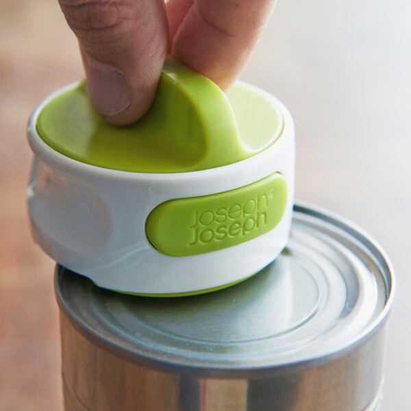 Can-Do Compact Can Opener in action on top of a can.