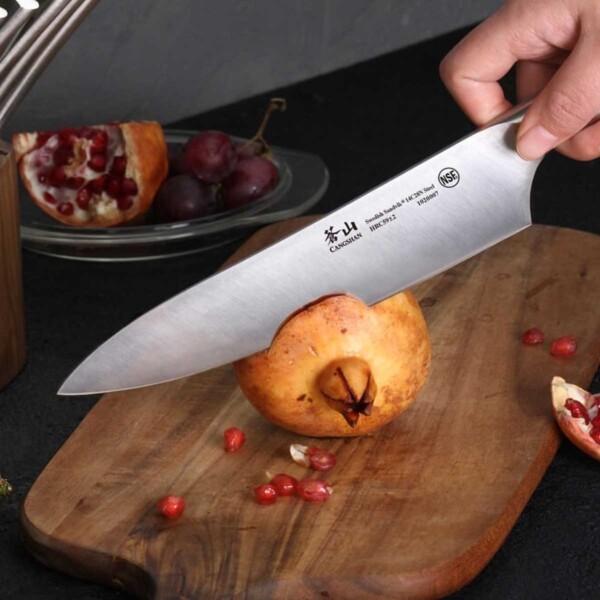 Cangshan TN1 Series 17-Piece Knife Block Set being used to cut pomegranate.