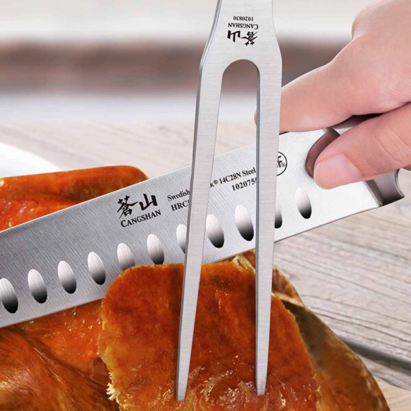 Close up of Cangshan TS Series 2 Piece Carving Set in use on roast turkey.