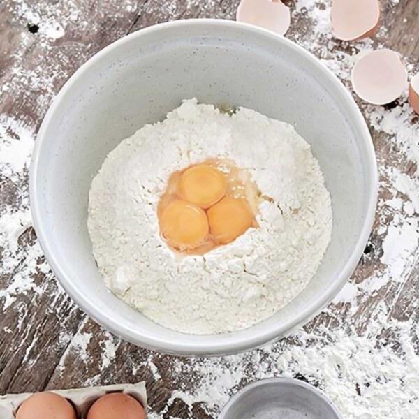 Casafina Fattoria Mixing Bowl top view with eggs and flour inside.