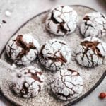 A plate with seven chocolate-ginger crinkle cookies