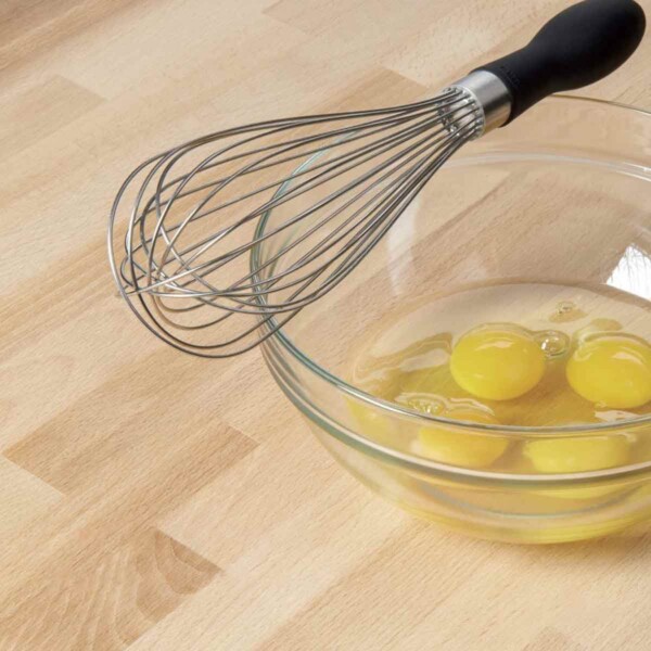 OXO Good Grips Balloon Whisk pictured with eggs in bowl.