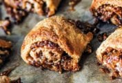 A dozen golden brown pecan pie rugelach with filling oozing out