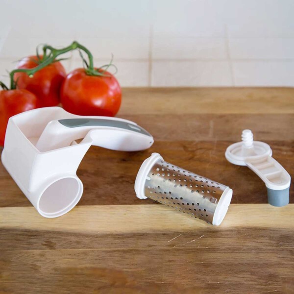 Zyliss Classic Rotary Cheese Grater on wood cutting board, disassembled.