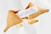 A broken fortune cookie with a fortune inside, representing the lucky foods you need to eat on New Years—and the unlucky ones you want to avoid.