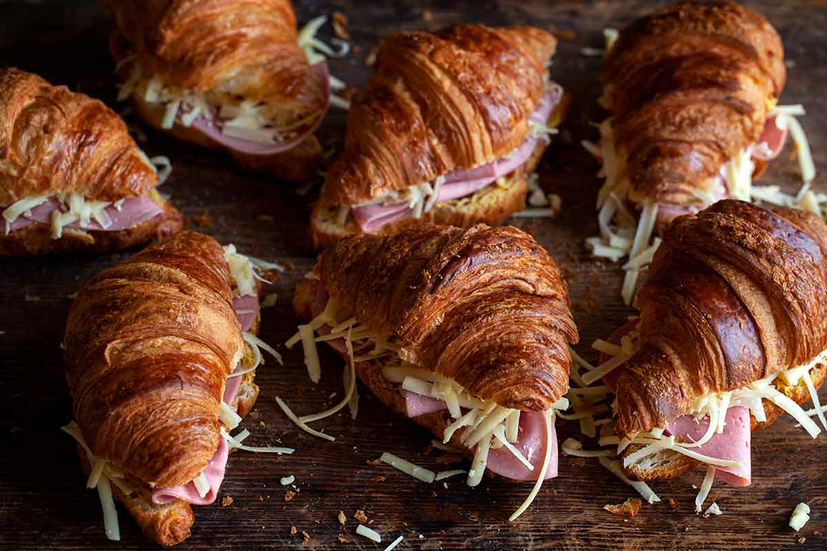 Croissants filled with ham and cheese for a croque monsieur casserole.