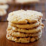 A stack of five old-fashioned peanut butter cookies, with crosshatch marks on top