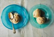 Two blue glass plates with scoops of Turkish coffee ice cream, and a spoon