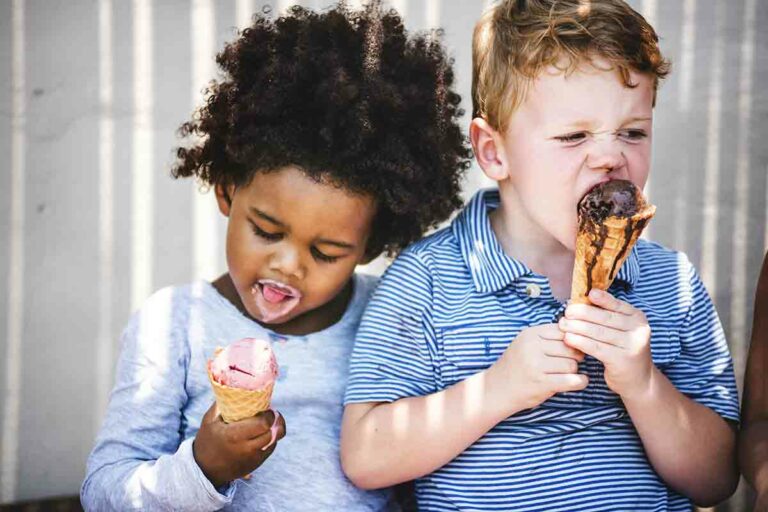 Two children eating ice cream cones