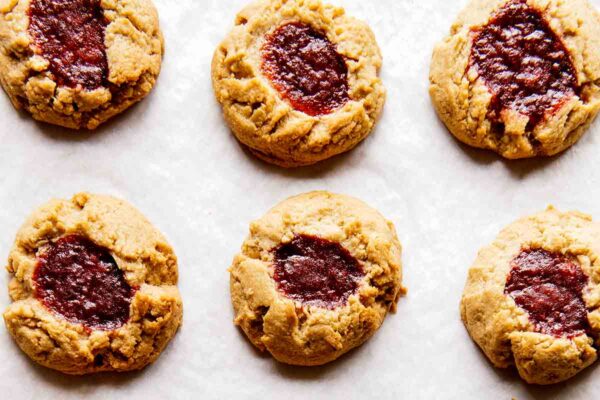 Six barley thumbprint cookies on parchment