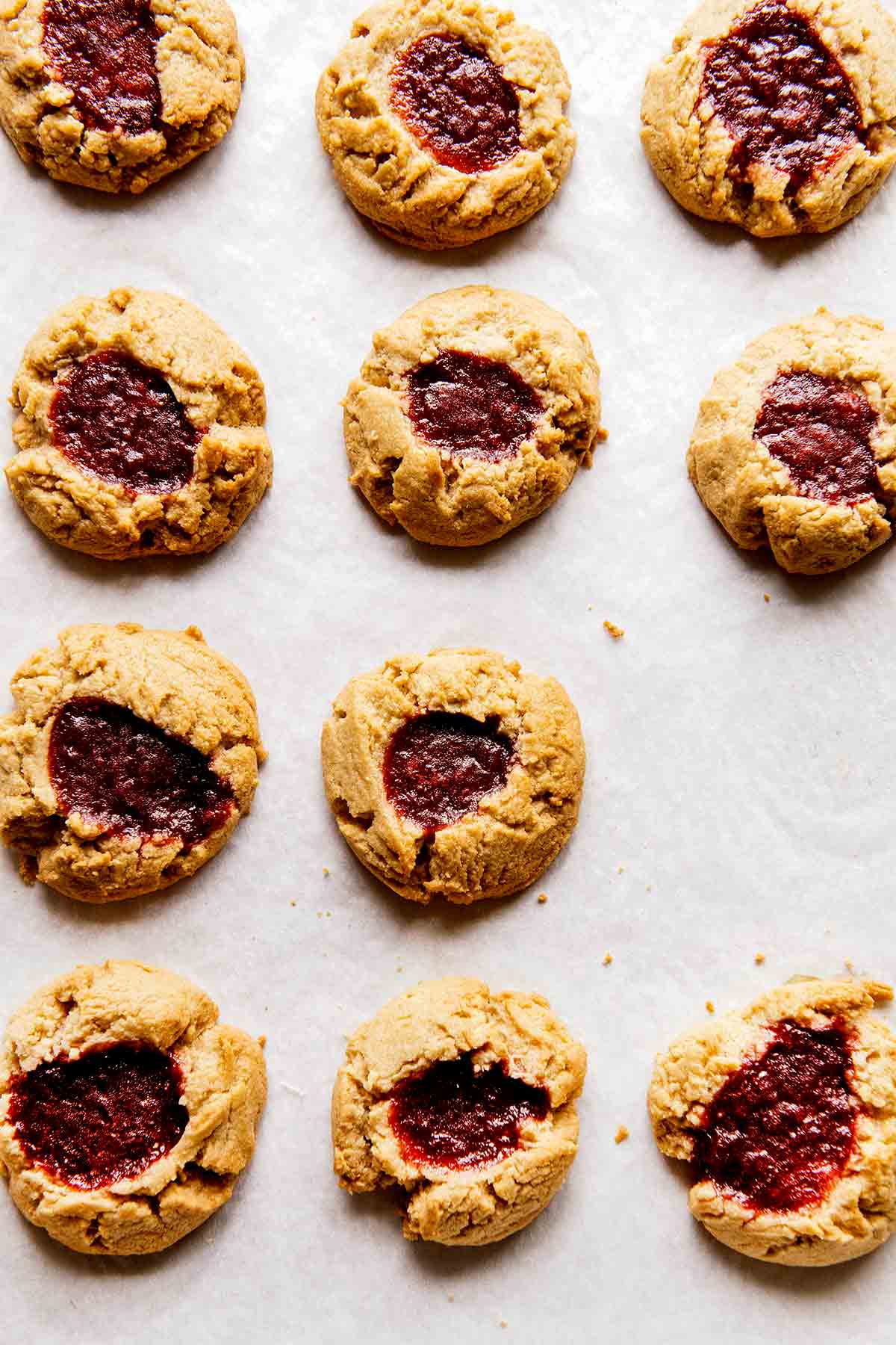 Eleven barley thumbprint cookies on parchment