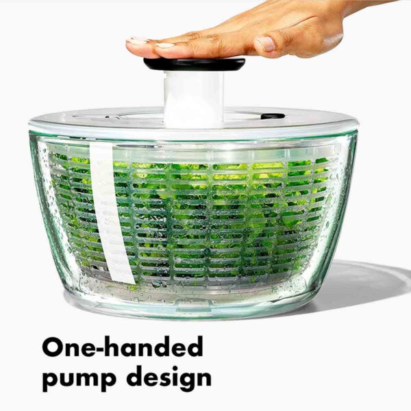 OXO Good Grips Glass Salad Spinner with hand on pump.