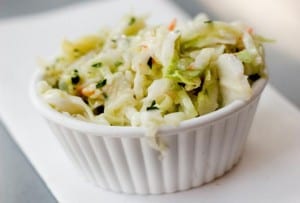 Small white ramekin filled with coleslaw with maple syrup